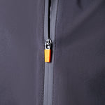 Close-up of a zipper on a dark gray jacket with an orange zipper pull.