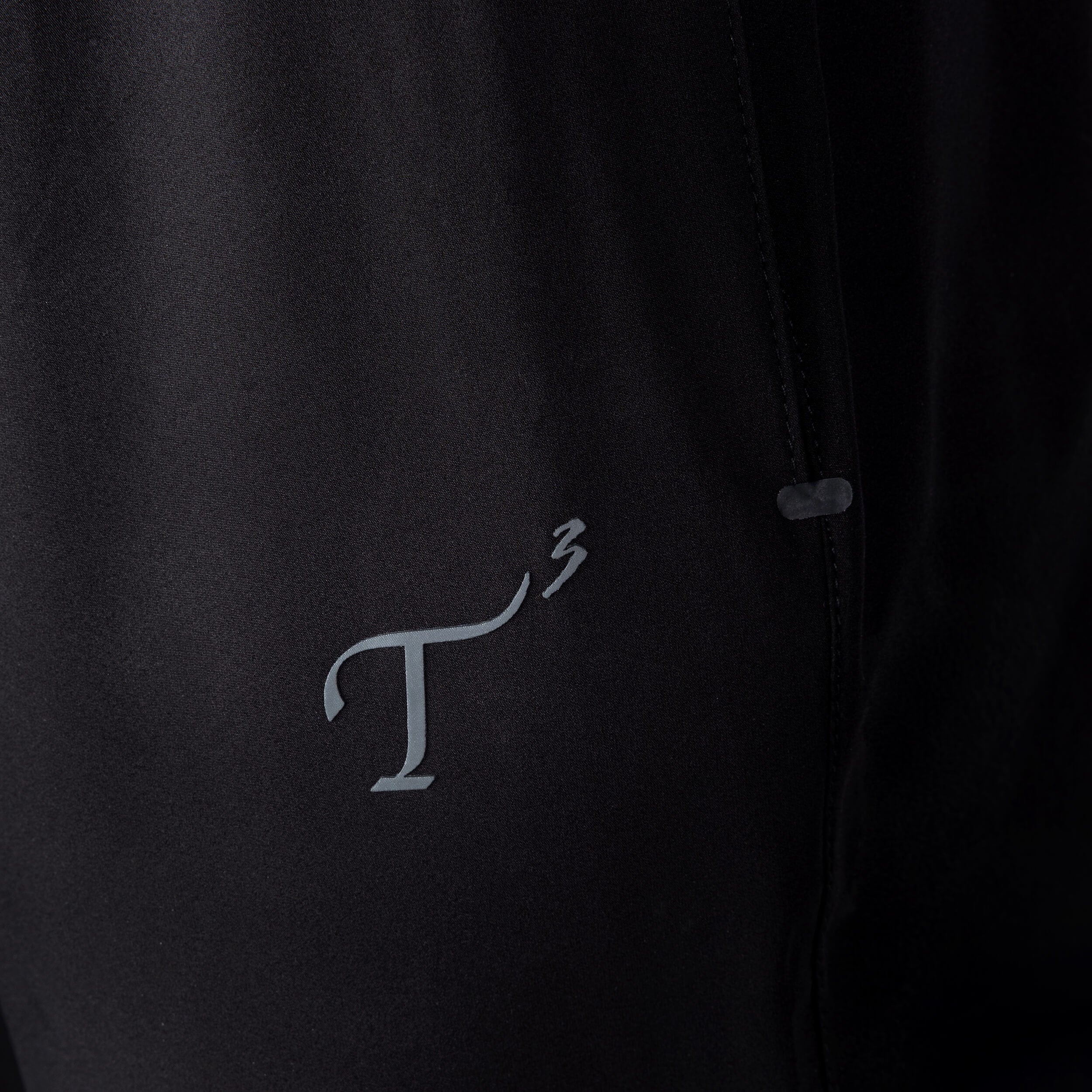 Close up of T3 logo on pant fabric