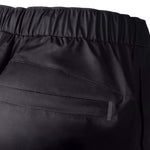 Close-up of black pants with a focus on the waistband and fabric texture.