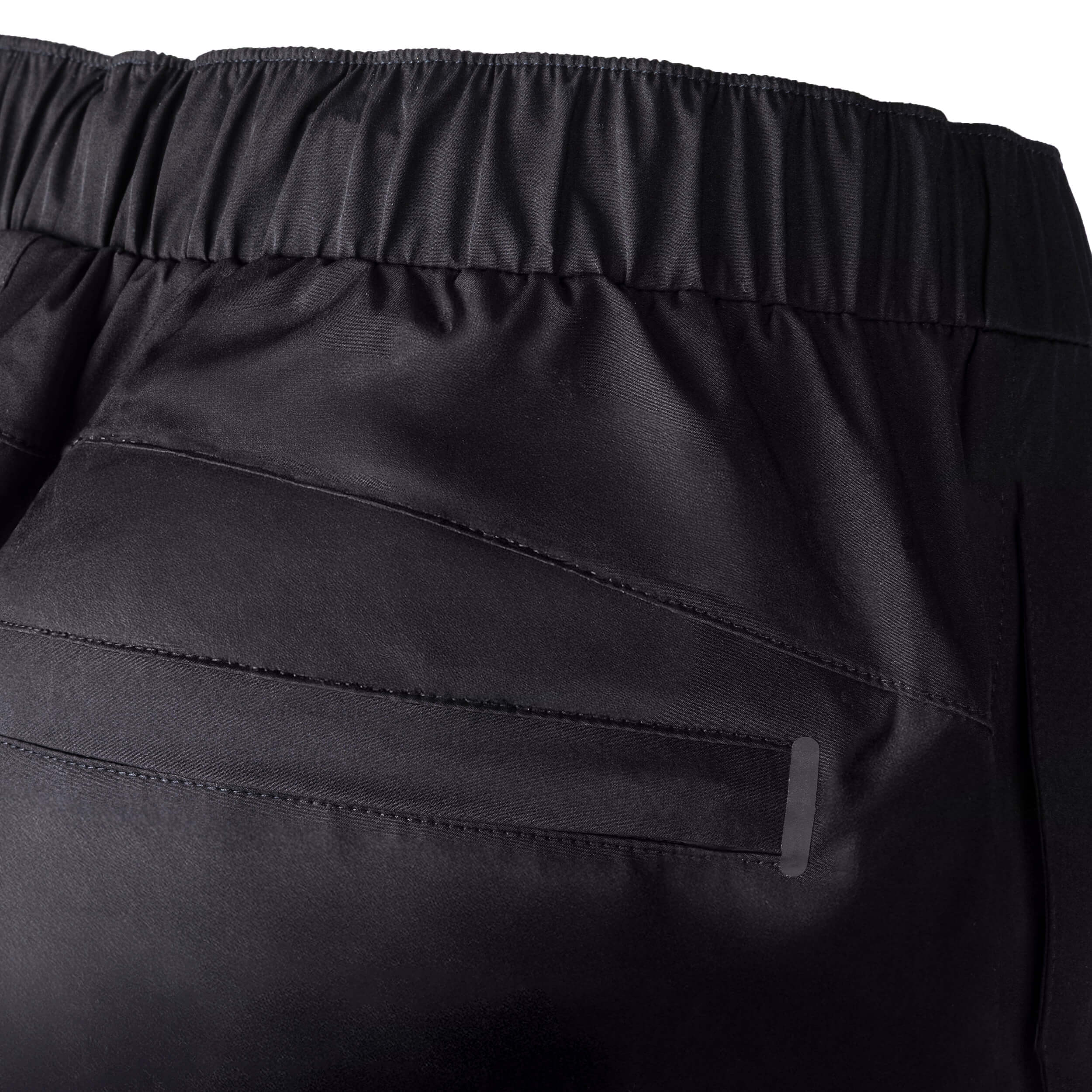 Close-up of black pants with a focus on the waistband and fabric texture.