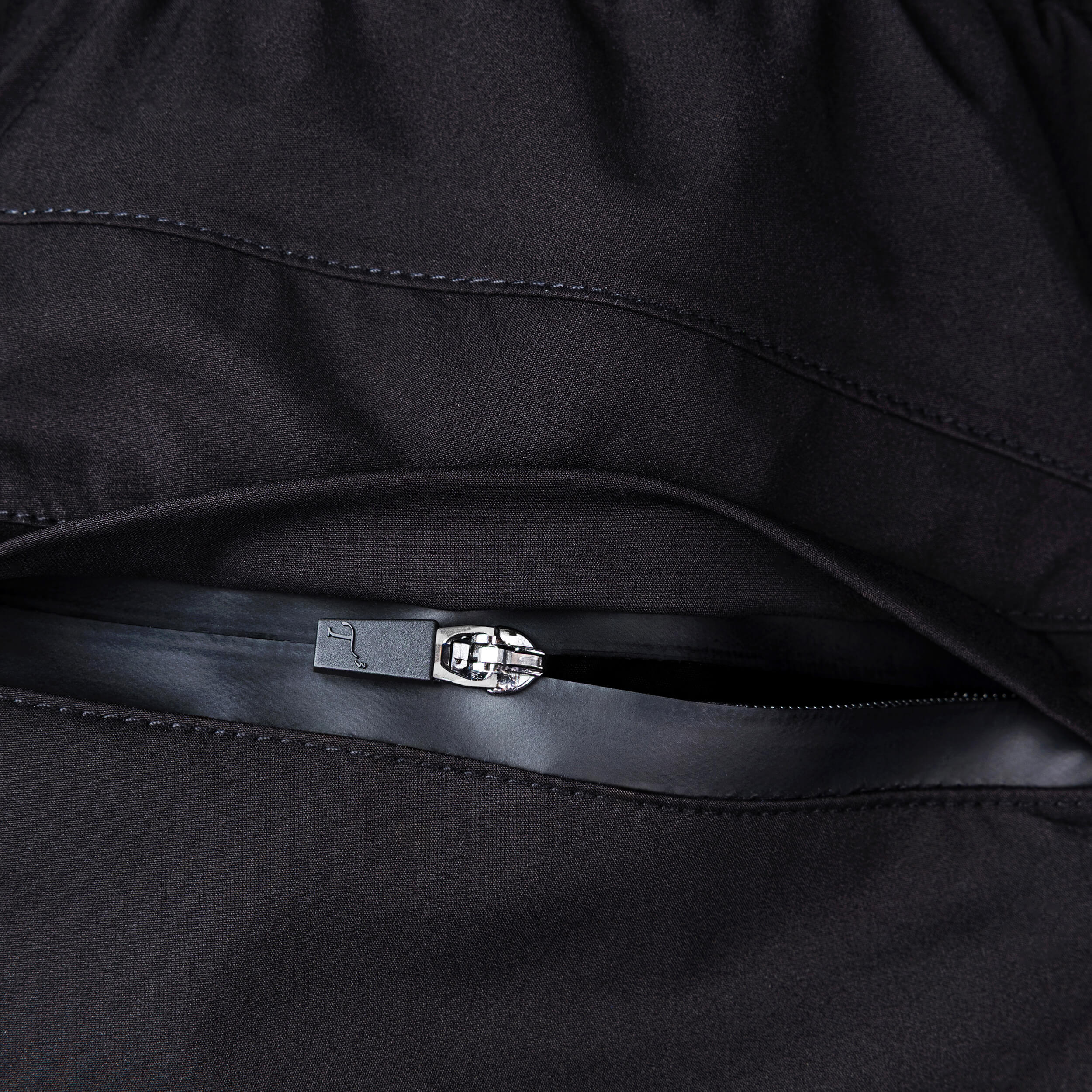 Close-up of back pant pocket with zipper opened